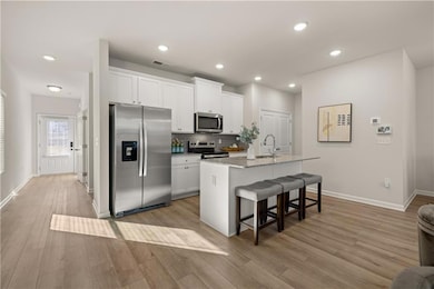 Kitchen featuring a breakfast bar area, a sink, wh