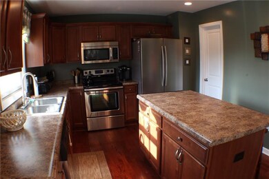Stainless Steel appliances. Door leads to pantry.