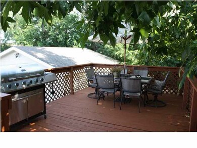 Oversize deck overlooks private shady yard with pl