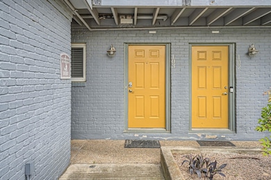 Doorway to property with brick siding