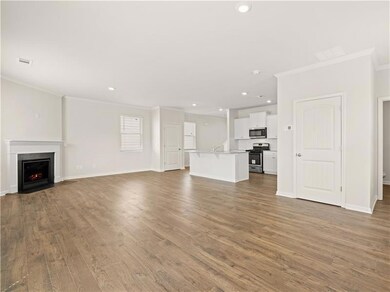 Unfurnished living room featuring ornamental moldi