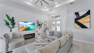 Living room with a tray ceiling, a towering ceilin