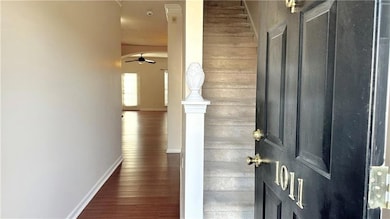 Corridor with baseboards and wood finished floors