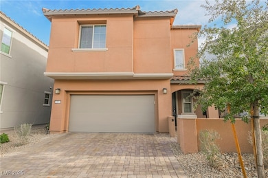 Mediterranean / spanish house with stucco siding, a garage, decorative driveway, and a tiled roof
