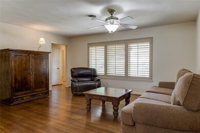 Neutral paint and ceiling fan enhance this room.