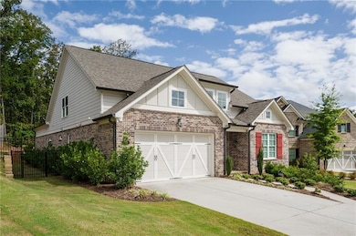 View of front of home with brick siding, a garage, a shingled roof, and driveway