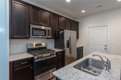 Granite countertops, subway backsplash, island, an