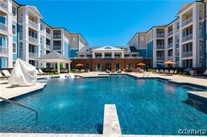 View of pool featuring a diving board