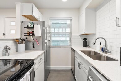 Kitchen featuring decorative backsplash, light st