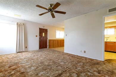 Living room, looking toward front entry, kitchen &