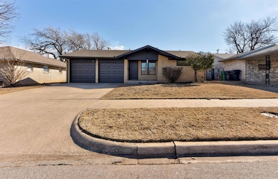 Ranch style home featuring brick siding, driveway,