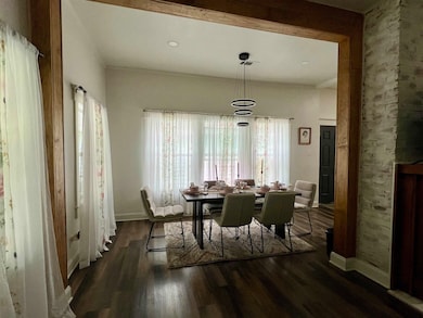 Dining room with wood finished floors and baseboar