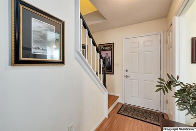 The foyer hall is spacious and has laminate wood floors.