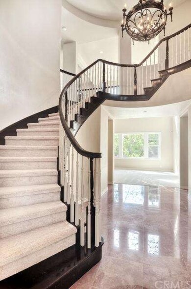 Grand entry, curved stairway, unique chandelier, w