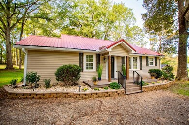 Single story home featuring a metal roof
