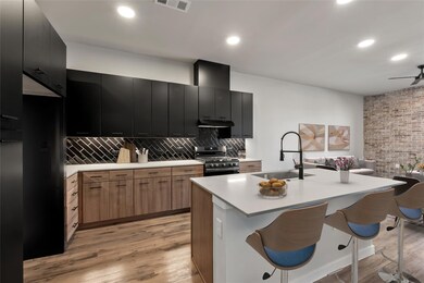 Kitchen featuring stainless steel gas range, a si