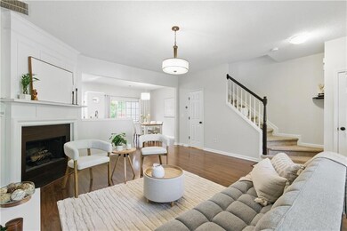 Living area with wood finished floors, stairway, a