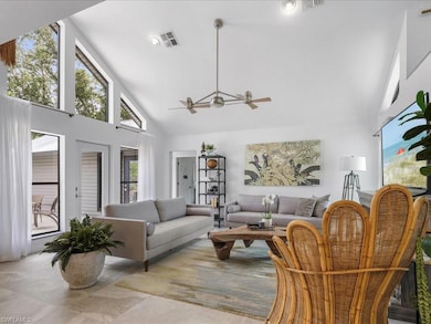 Living room with high vaulted ceiling and double ceiling fan