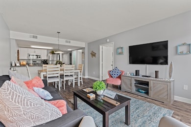 Living room featuring visible vents, a textured ce