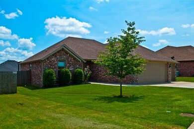 Beautiful manicured front lawn. treated for weeds with young tree and beautiful scented rosebush