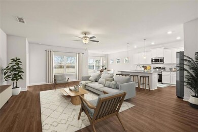 Living room featuring ceiling fan, sink, and dark 