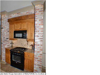 Interior brick encases the gas top oven, microwave