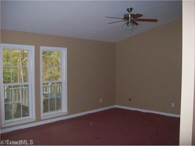 Living Room. Note the tall windows (throughout the house) and vaulted ceiling with laminate floors.
