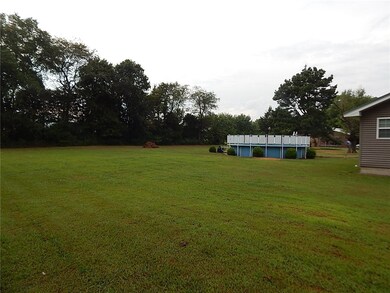 An acre of pretty lawn and well kept pool in back!