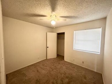 Unfurnished bedroom featuring a textured ceiling,
