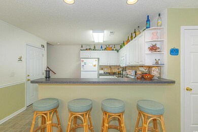 Kitchen featuring a peninsula, dark countertops, o