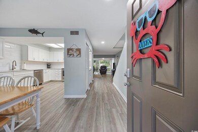 Foyer entrance featuring light wood-style floors, baseboards, and recessed lighting