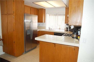cozy kitchen with ample cabinets and counter tops.