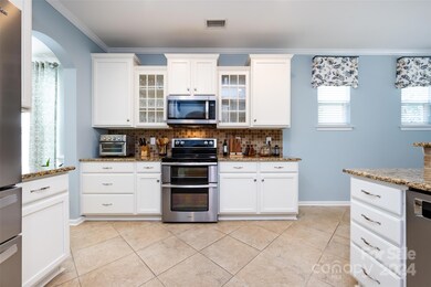 Granite counters and 42 inch white cabinets