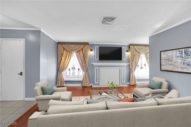 Living area with ornamental molding and a textured