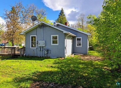 View of side of home featuring a deck and a yard