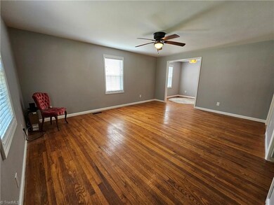 Front entry into living room with wood floors
