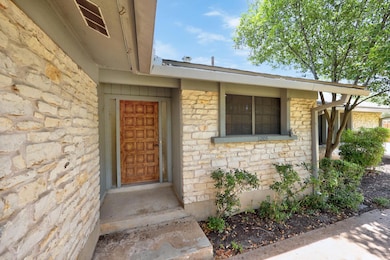 View of exterior entry featuring stone siding