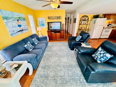 Living room featuring ceiling fan and wood-type flooring