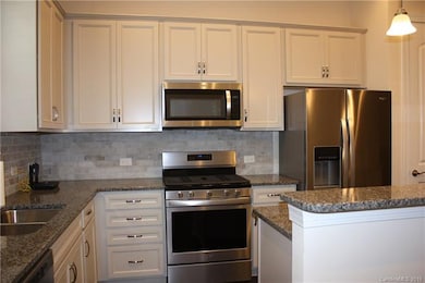 Kitchen is beautifully appointed w/ Granite Counte