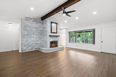 Love this fireplace with brick hearth and window s