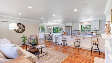 Beautiful, light-filled living room features easy-care vinyl plank flooring and open sight lines into the gorgeous kitchen!