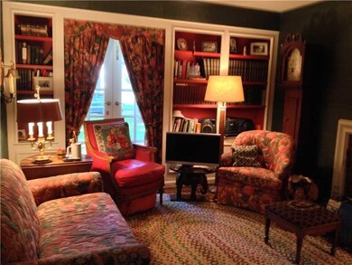 Den. Hardwood floors, fireplace, built in cabinets