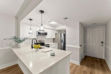 Renovated Kitchen with Quartz Countertops, White Cabinets and Large Island.