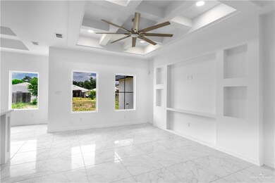 Tiled spare room with coffered ceiling and ceiling fan