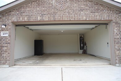 Garage with electric water heater and concrete dr
