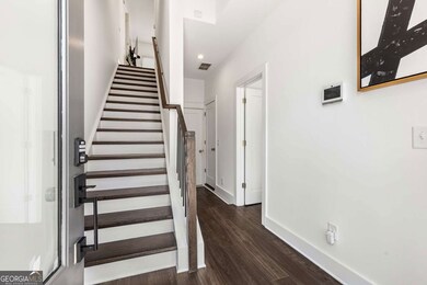 Entryway with staircase, entrance to bedroom/office, storage closet and 2-car garage