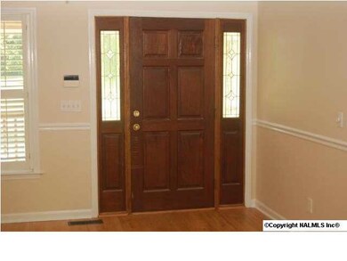Front door with glass panels welcomes you inside.