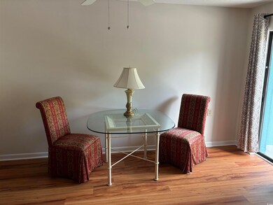 Living area featuring wood-type flooring and ceili