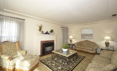 Living room with wood burning fireplace.