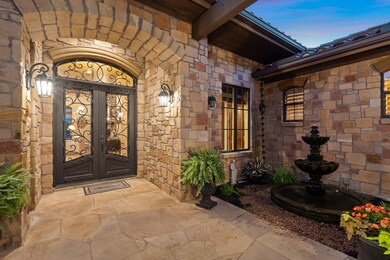 Exterior entry at dusk with french doors and ston